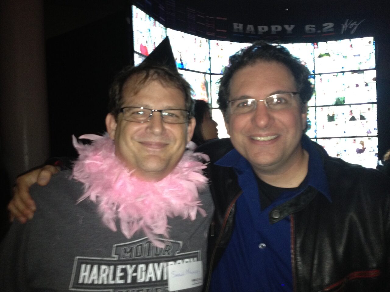 Shawn Nunley wearing a pink boa with Kevin Mitnick at Steve Wozniak's birthday party