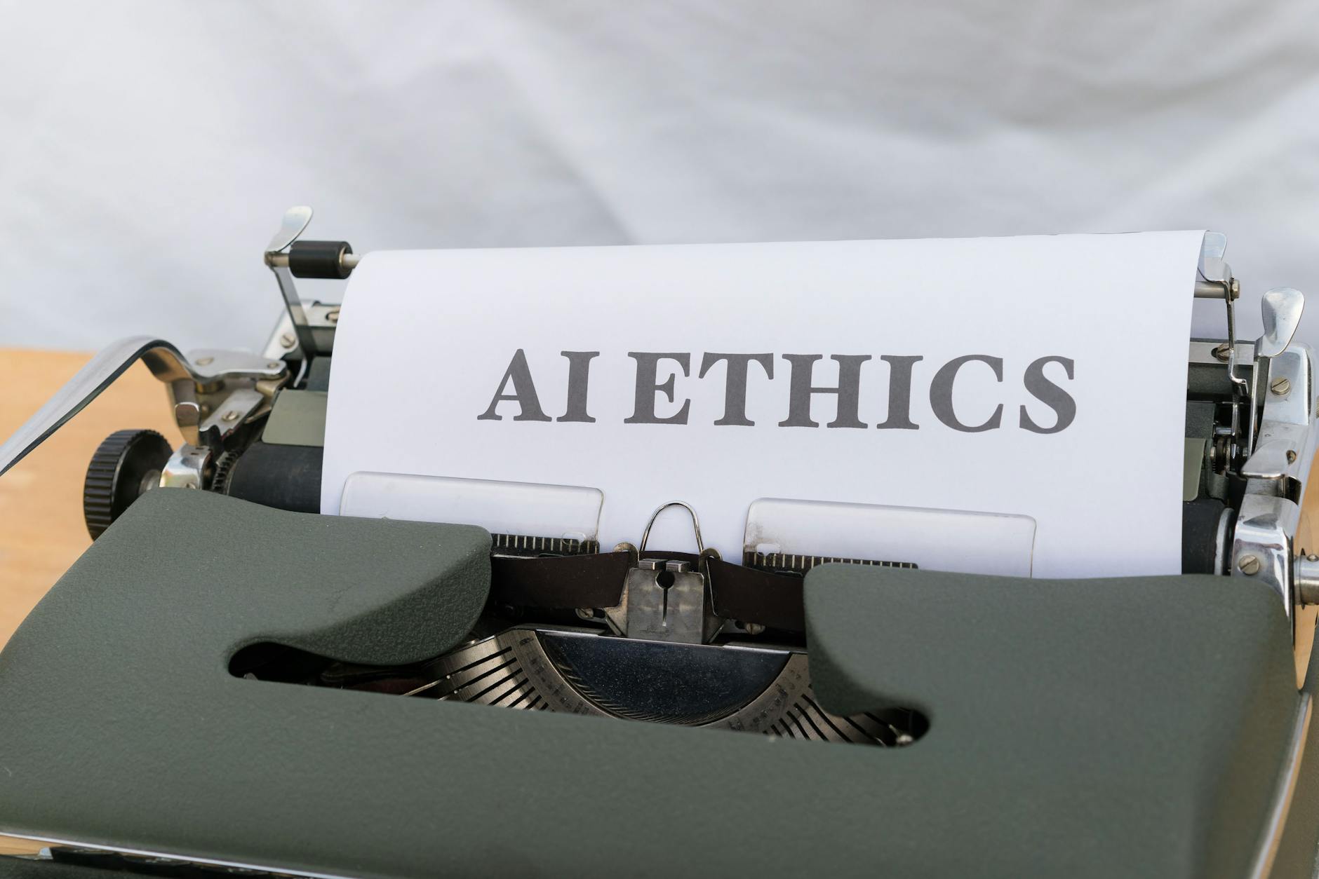 Close-up of a vintage typewriter with 'AI ETHICS' typed on paper