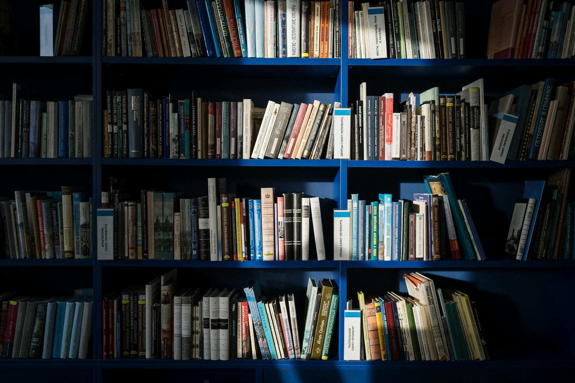 A well-stocked bookshelf filled with various books in a library setting