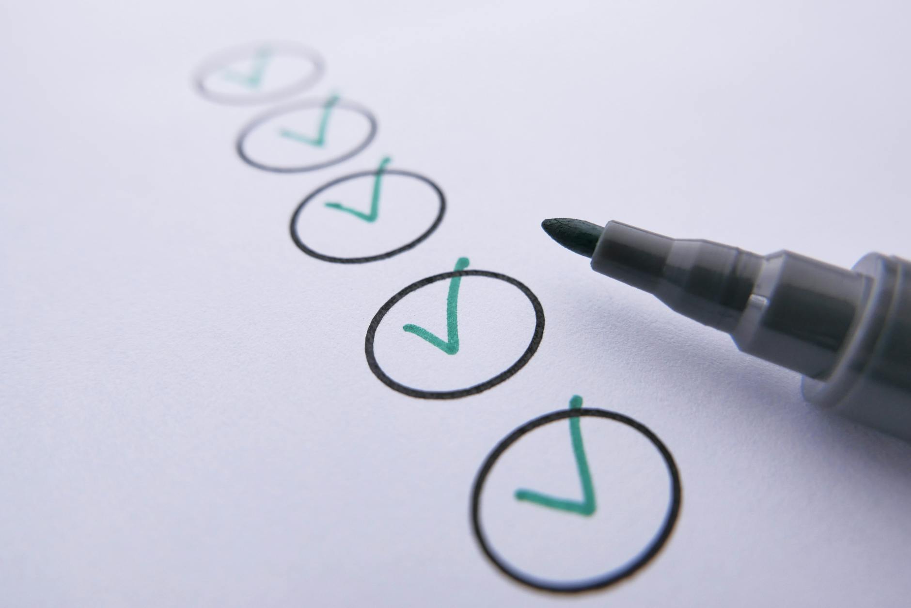Close-up of a checklist with green checkmarks