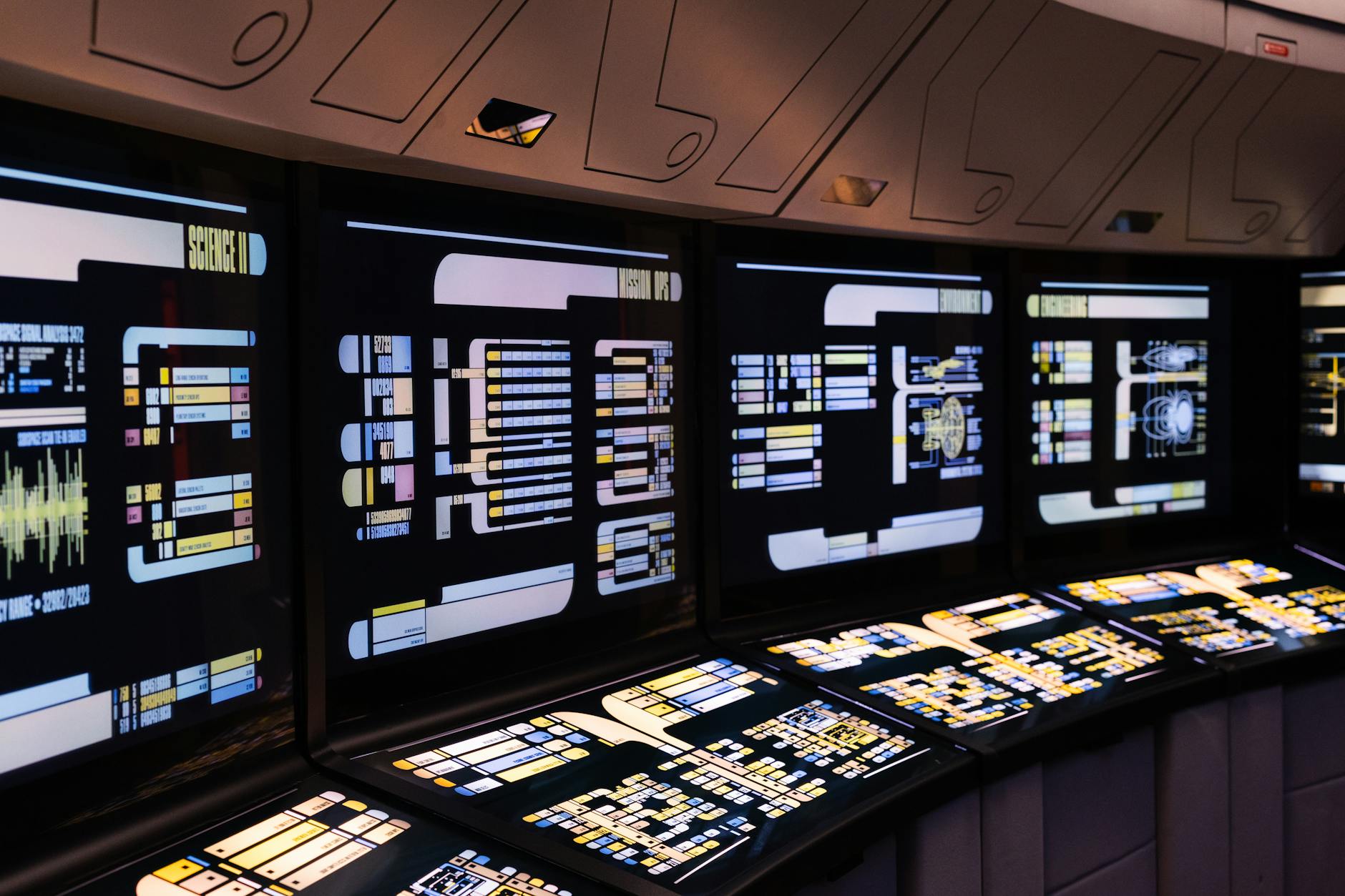 A high-tech command center with illuminated digital screens