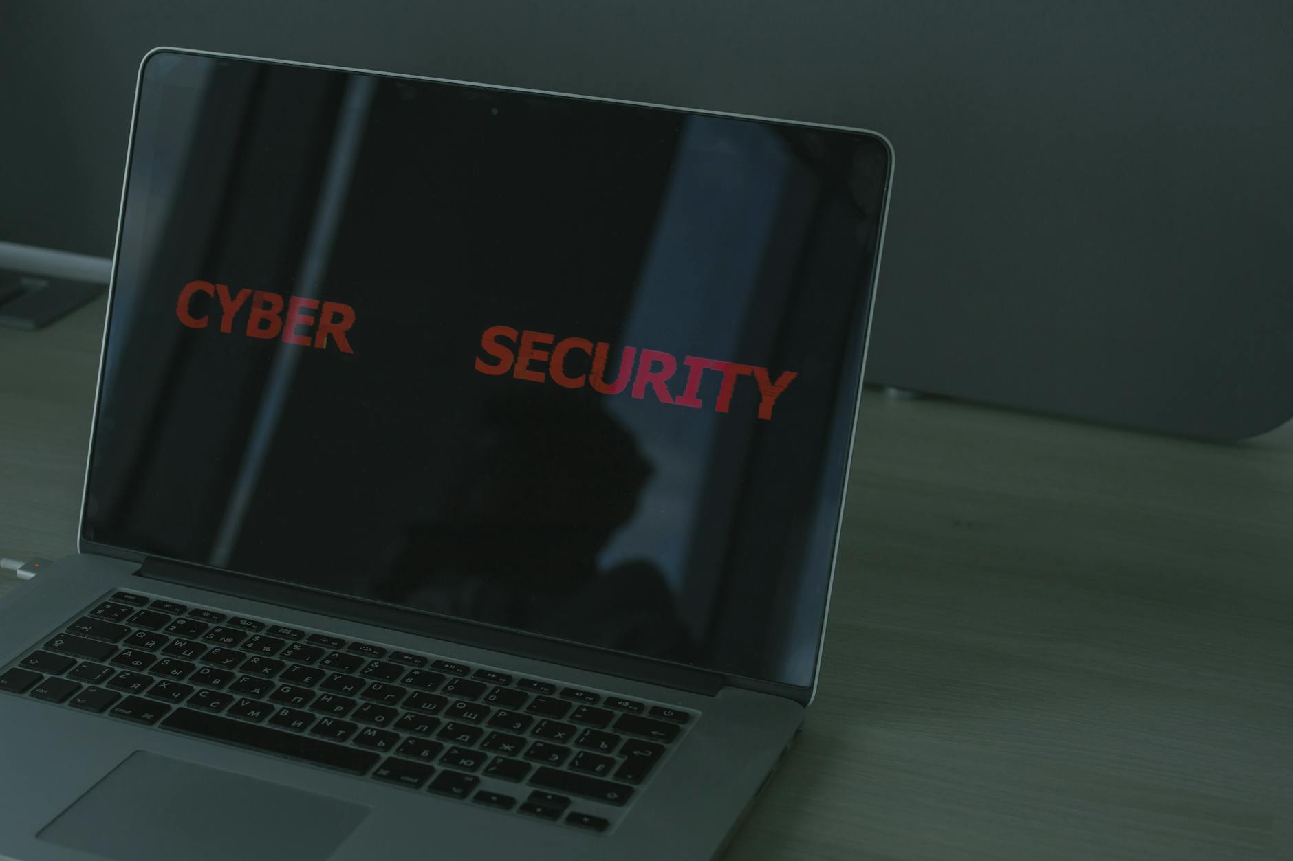 Close-up of a laptop displaying cybersecurity text, emphasizing digital security themes