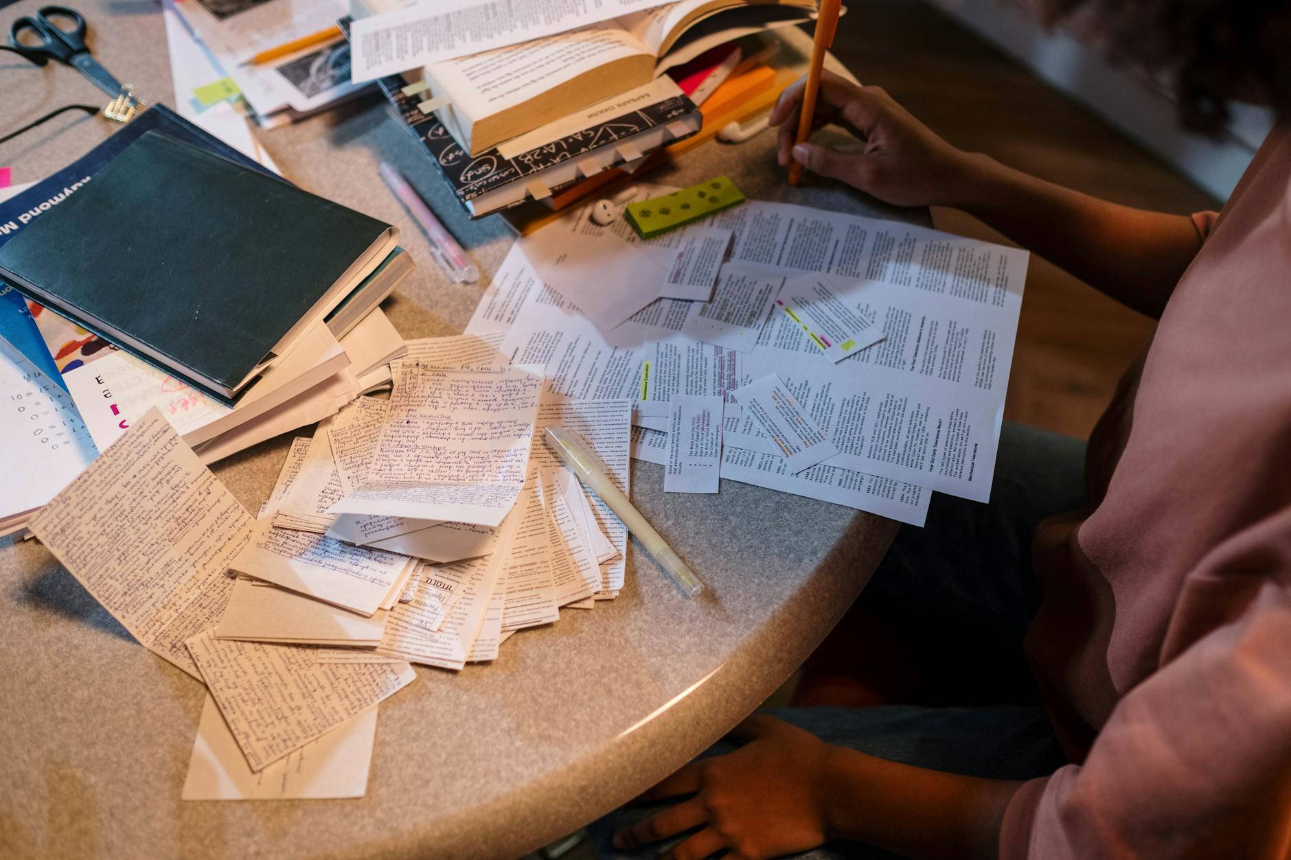 A student organizes notes and books in preparation for an exam