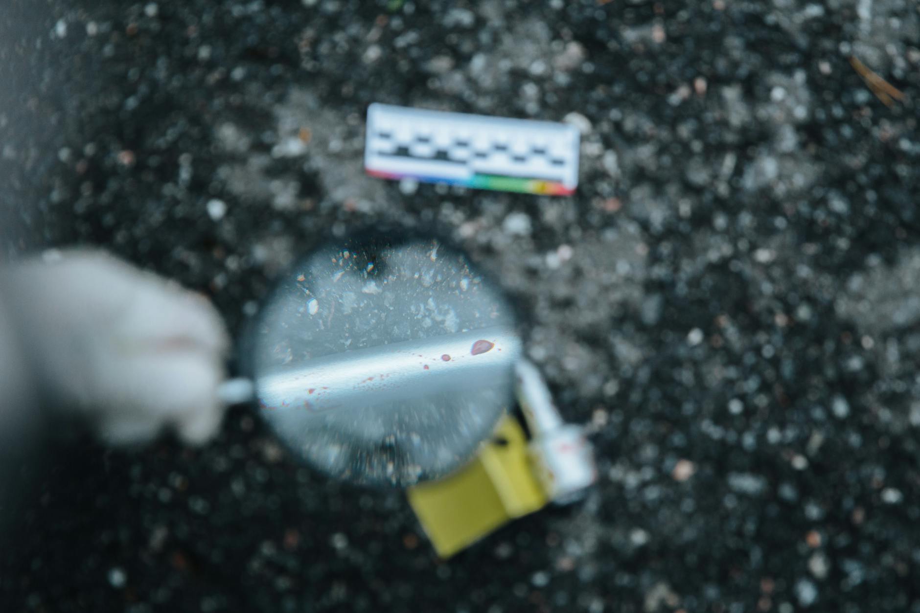 Close-up of evidence analysis with a magnifying glass