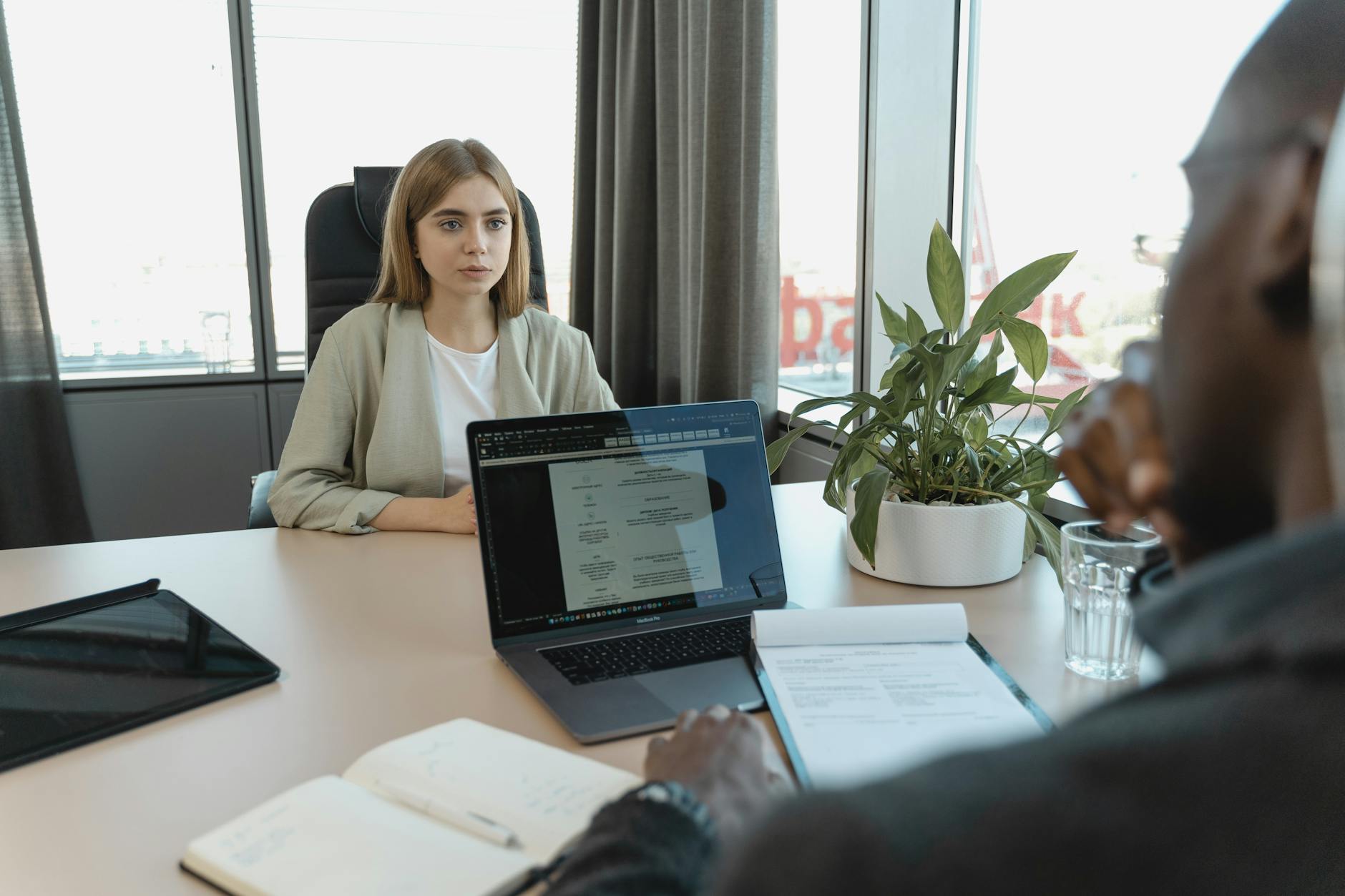 A professional job interview scene in a modern office setting