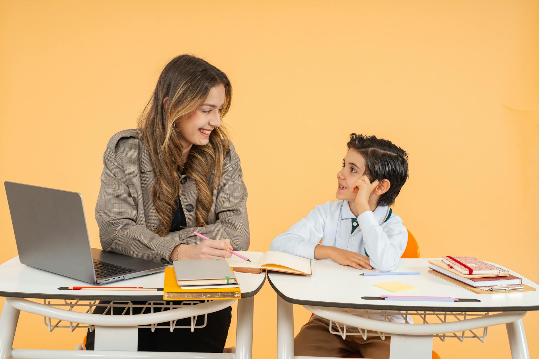 A teacher and student smiling as they engage in a learning activity