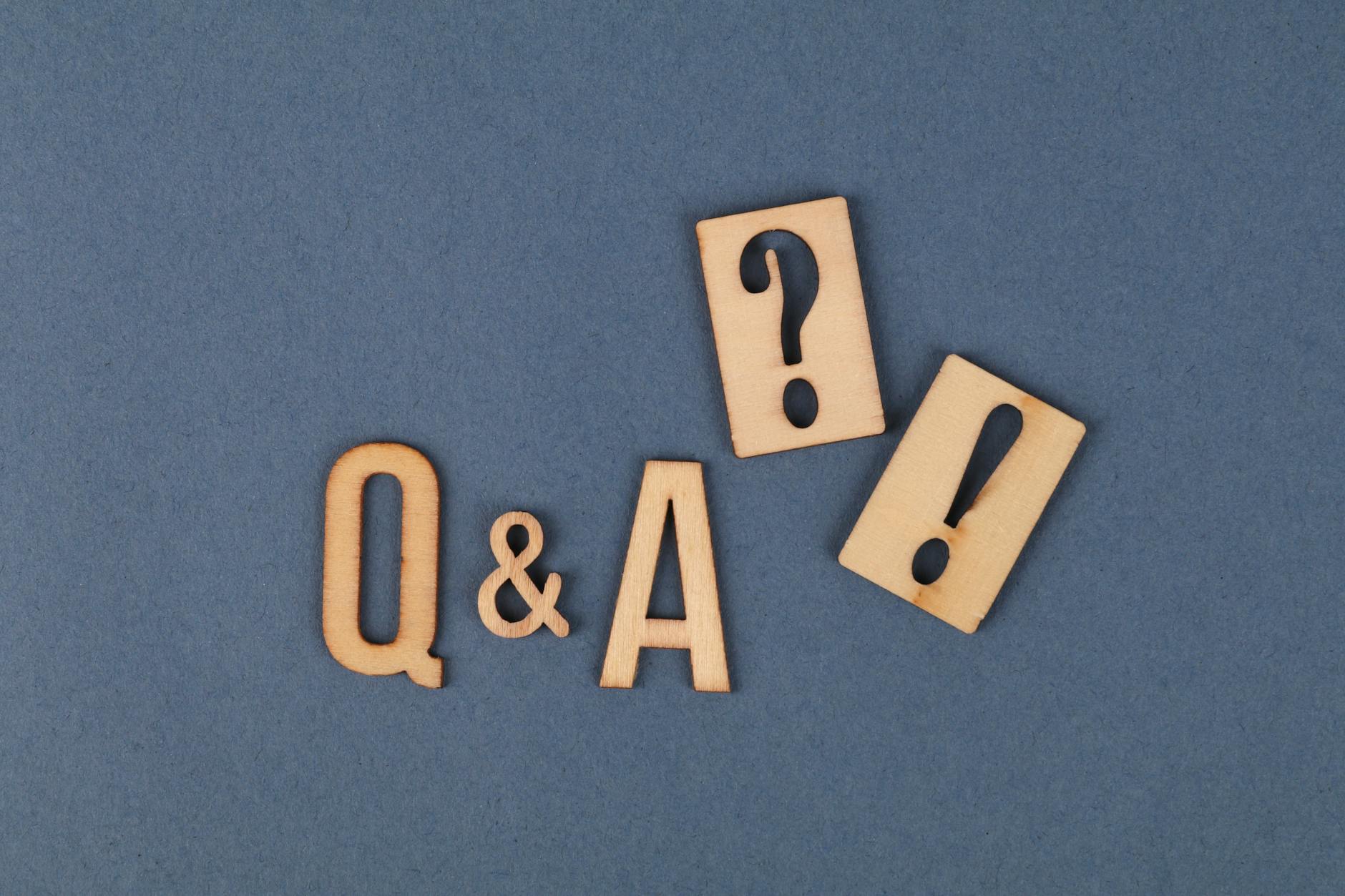 Flat lay of wooden Q&A letters with punctuation marks