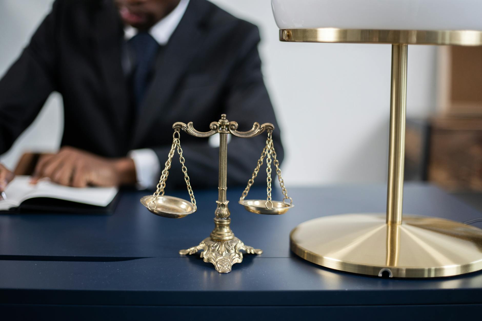 Elegant balance scales of justice on a sleek dark desk