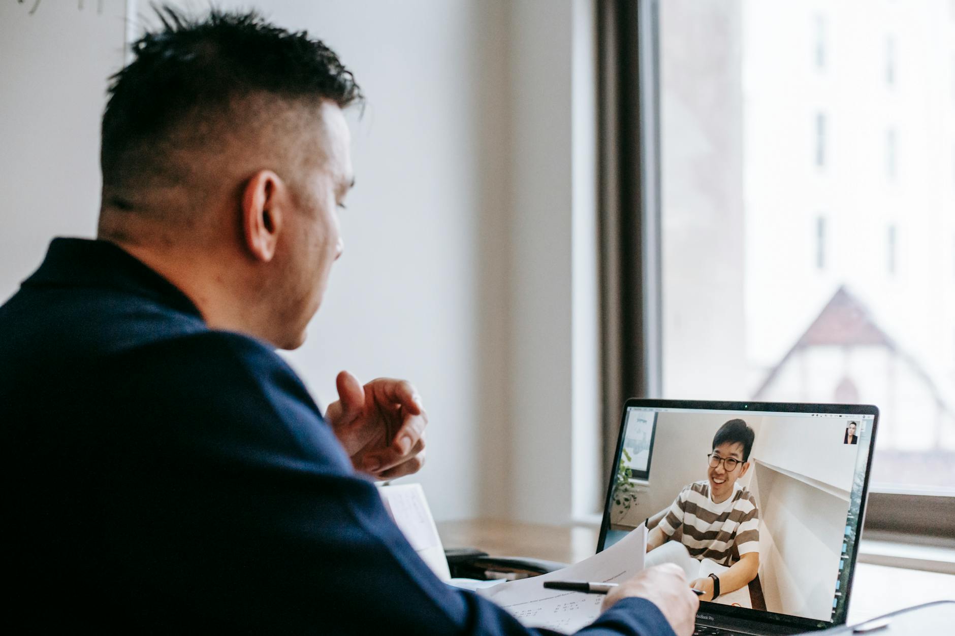 Professionals on a video conference call between colleagues in an office