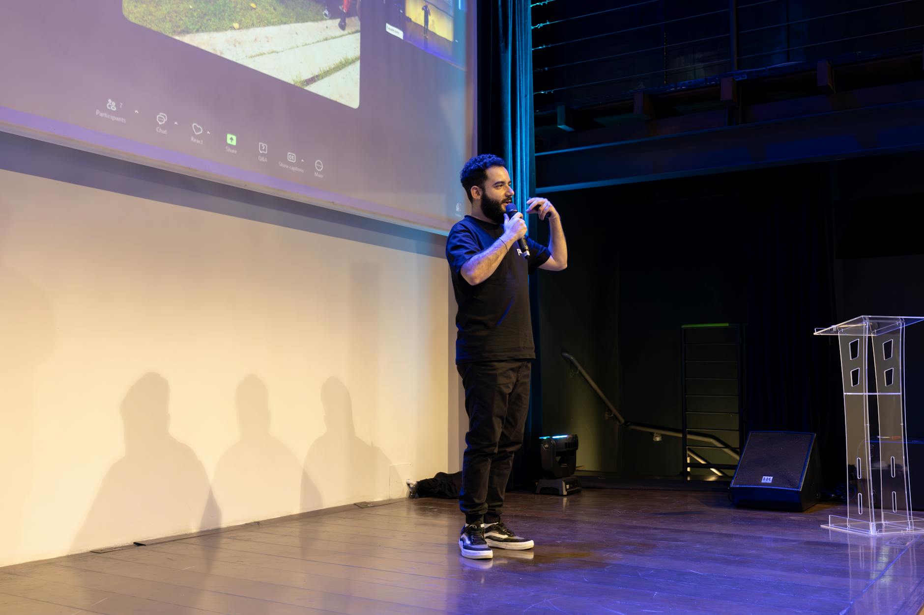 An energetic speaker delivering a talk at a corporate event